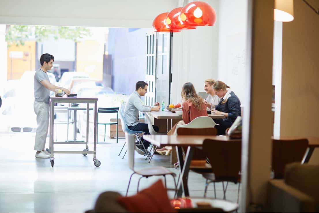 employees talking in lunch room by door